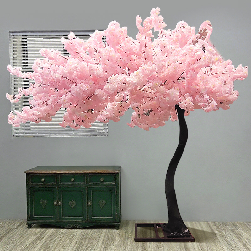 Simulated pink cherry blossom trees create a romantic indoor scene