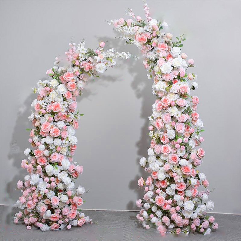 A sweet atmosphere is created in the pink and white floral arch wedding welcome area/ceremony passage