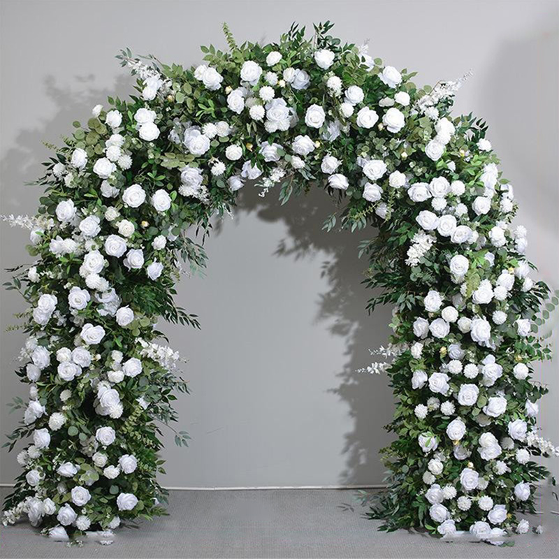 The romantic floral door for the wedding celebration is decorated with white rose and green leaves