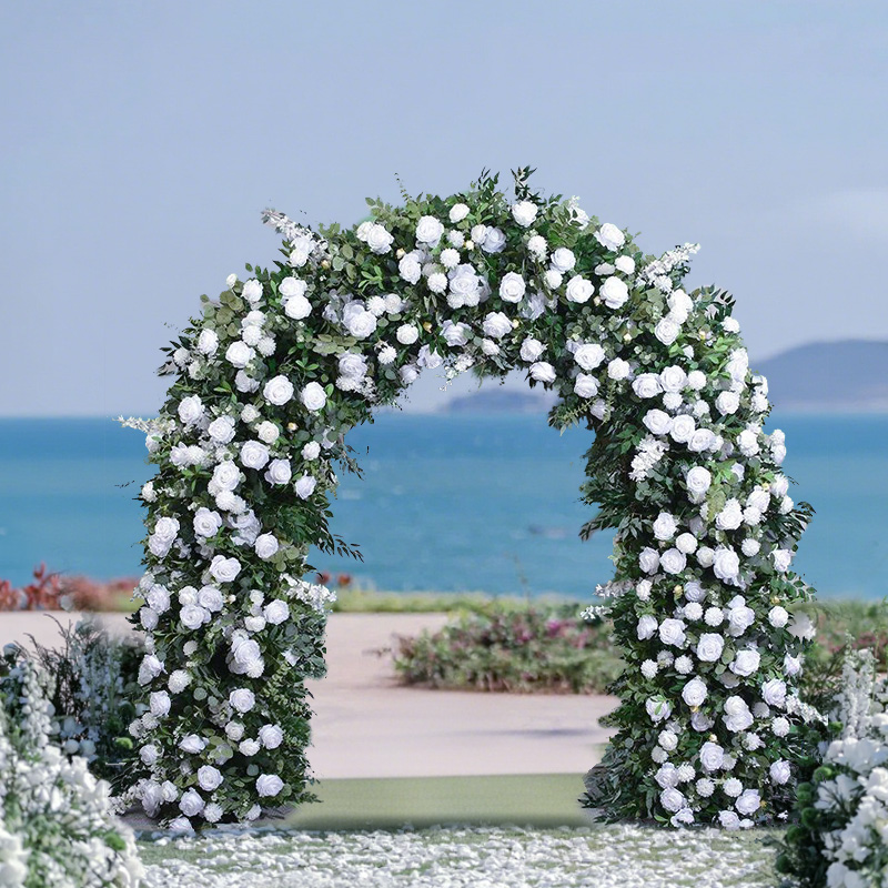 The white floral arch for the seaside wedding and the decorative arch for the outdoor wedding ceremony passage